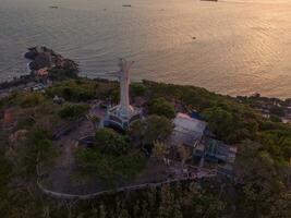 Aerial view of Vung Tau city, Vietnam, panoramic view of the peaceful and beautiful coastal city behind the statue of Christ the King standing on Mount Nho in Vung Tau city. photo