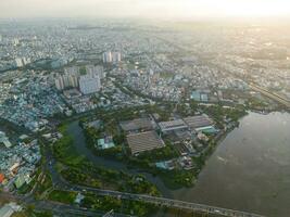 Panoramic view of Saigon, Vietnam from above at Ho Chi Minh City's central business district. Cityscape and many buildings, local houses, bridges, rivers photo