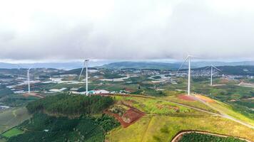 Beautiful landscape in the morning at Cau Dat, Da Lat city, Lam Dong province. Wind power on tea hill, morning scenery on the hillside of tea planted photo