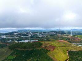 Beautiful landscape in the morning at Cau Dat, Da Lat city, Lam Dong province. Wind power on tea hill, morning scenery on the hillside of tea planted photo