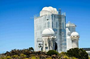 the large white building has three domes on top photo