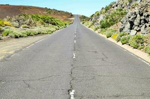 an empty road with a white line on it photo