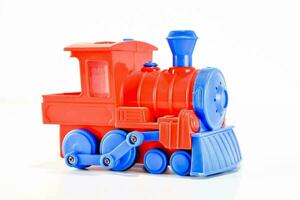 a toy train is sitting on a white surface photo