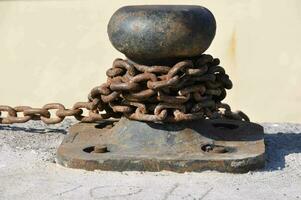 a rusty ball with chains attached to it photo