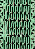 a green metal grate with a pattern of circles photo