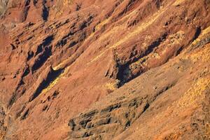 a mountain with red and yellow colors photo