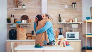 Cheerful couple smiling and dancing in kitchen. Romantic husband and wife. Cheerful happy young family together dance. Fun love affection romance leisure romantic music for enjoynment photo