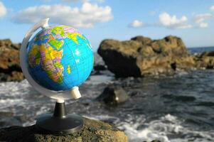 the world globe on the rocks photo