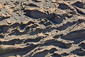 a rock formation with many holes and cracks photo