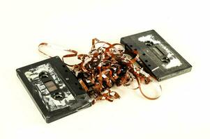 two old cassette tapes on a white surface photo