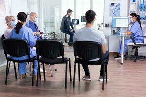 Handicapped woman with walking frame wearing protective mask against coronavirus. Social distancing, medic, covid-19, man, worried, protection, corona, medicine, medical, nurse, talking, virus. photo