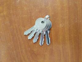 AI generated Bunch of keys on wooden background, closeup of photo. photo