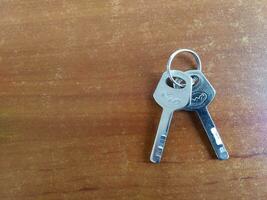 AI generated Key ring on a wooden background. Top view. Copy space. photo