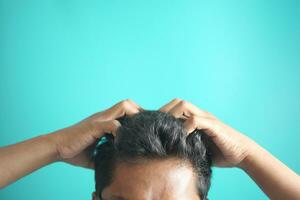 men Scratching Head Against color background . photo