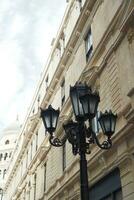 Elegant street lamp surrounded by buildings photo