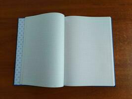 AI generated Notebook on the wooden table. Top view with copy space photo