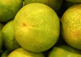 Exotic orange fruit, lemon, or lime. Fresh and healthy fruit photo