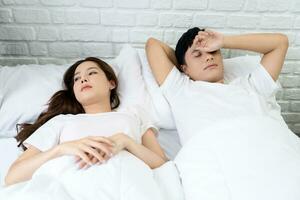 unhappy couple having conflict in bed at home. Relationship problem concept photo