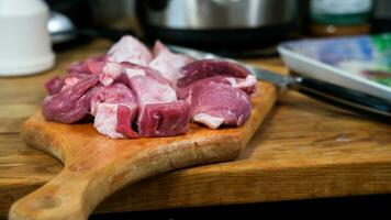 Pork meat on cutting board close up photo