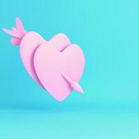 Pink two heart pierced by cupid arrow on bright blue background in pastel colors photo