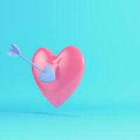 Pink heart pierced by cupid arrow on bright blue background in pastel colors photo