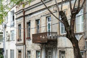 old urban house with rusty balcony in Tbilisi city photo