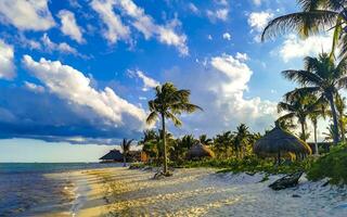 Tropical Caribbean beach people parasols fun Playa del Carmen Mexico. photo