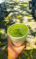 Green healthy juice smoothie in to go cup in Mexico. photo