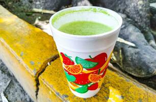 Green healthy juice smoothie in to go cup in Mexico. photo