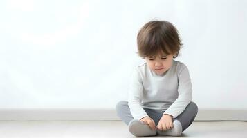 AI generated Sad little boy with mental trauma sitting on floor. photo