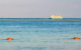 Boats yachts ship catamaran jetty beach Playa del Carmen Mexico. photo