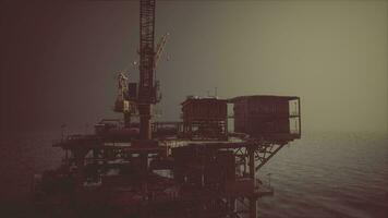 An oil rig standing tall in the vastness of the ocean video