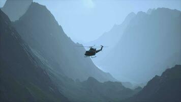 A helicopter is flying over a mountain range video