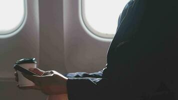 Asian young woman using laptop sitting near windows at first class on airplane during flight,Traveling and Business concept video