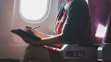 Asian young woman using laptop sitting near windows at first class on airplane during flight,Traveling and Business concept video