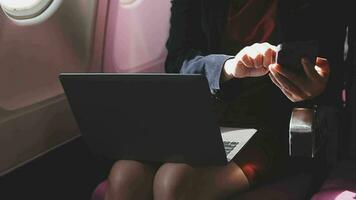 Asian young woman using laptop sitting near windows at first class on airplane during flight,Traveling and Business concept video