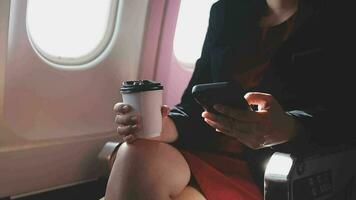 Asian young woman using laptop sitting near windows at first class on airplane during flight,Traveling and Business concept video