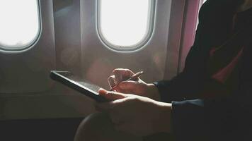 Asian young woman using laptop sitting near windows at first class on airplane during flight,Traveling and Business concept video