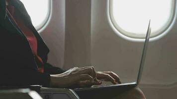 Asian young woman using laptop sitting near windows at first class on airplane during flight,Traveling and Business concept video