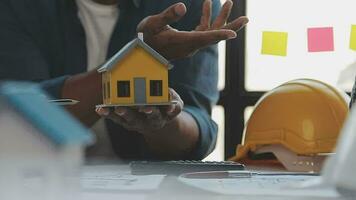 Hands of architect or engineer working on blueprint meeting for project working with partner on model building and engineering tools in working site, Construction and structure concept. video