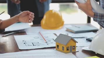 Hands of architect or engineer working on blueprint meeting for project working with partner on model building and engineering tools in working site, Construction and structure concept. video