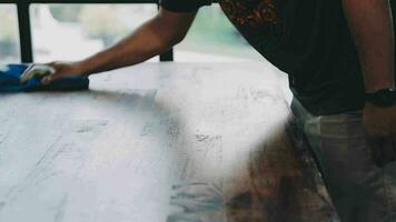 Woman cleaning table using rag and diffuser at home. video