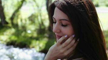 Portrait. Beautiful girl posing face in sunny summer weather. Slow motion video