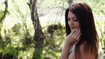 Portrait. Beautiful girl posing face in sunny summer weather. Slow motion video