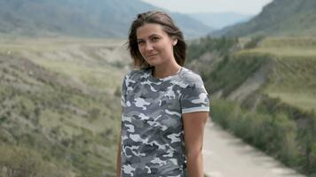 Portrait of attractive girl tourist on a background of mountains and river video