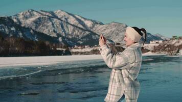 Woman tourist makes photo of nature using smartphone. video