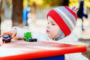 the kid plays cars on the street photo