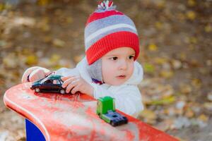 the kid plays cars on the street photo