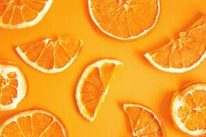 Orange chips on an orange background, top view. A healthy snack. photo