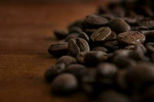 Roasted coffee beans on a wooden background, close up. Copy space. photo